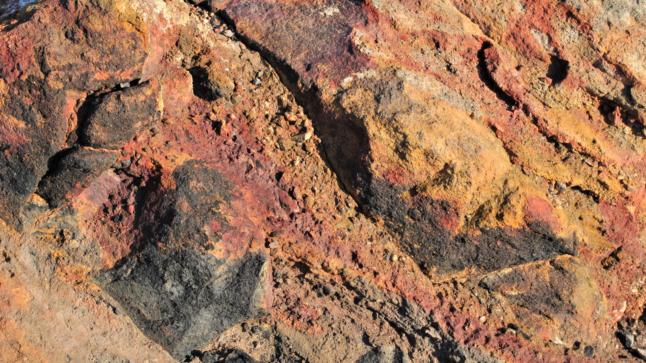 The colors of lava: Oxidation on the rocks of Nea Kameni creates colorful patterns